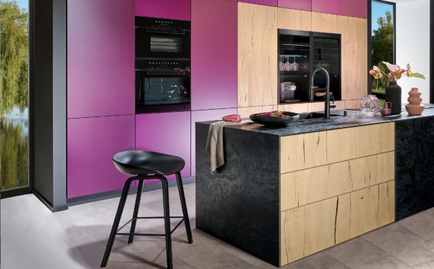 Bild einer modernen Küche mit violetten Fronten, in Holzoptik hell und schwarz mit Insel